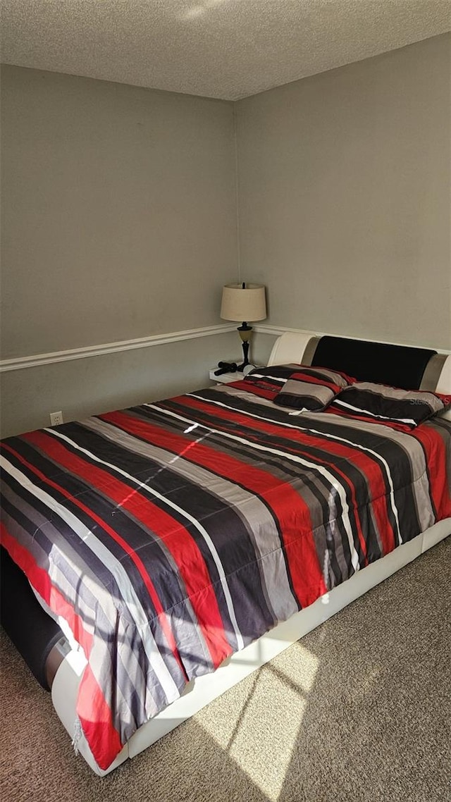 carpeted bedroom featuring a textured ceiling