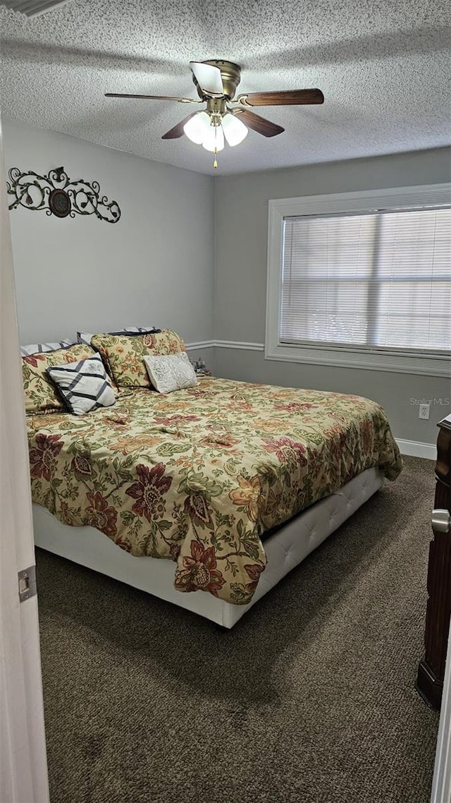 bedroom featuring carpet, a textured ceiling, and ceiling fan