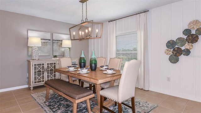 dining room with a chandelier and light tile patterned floors