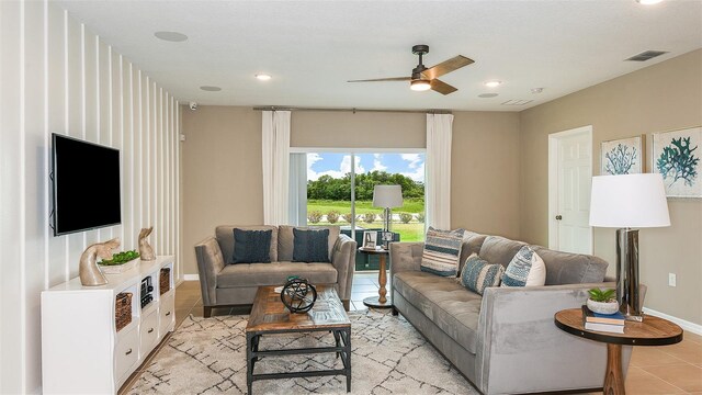 tiled living room featuring ceiling fan