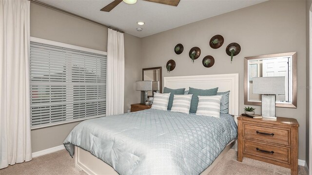 bedroom with light colored carpet and ceiling fan