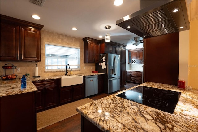 kitchen with stainless steel appliances, island range hood, dark wood-type flooring, sink, and decorative light fixtures