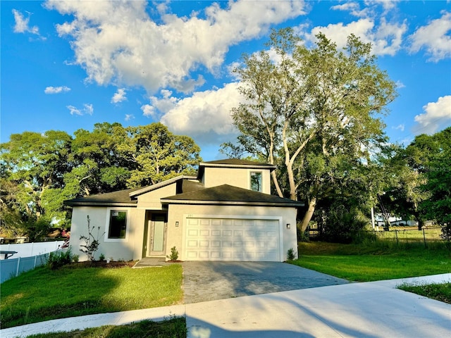 view of front of home featuring a front yard and a garage