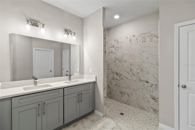 bathroom with vanity and tiled shower