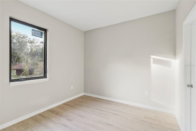 empty room with light hardwood / wood-style flooring