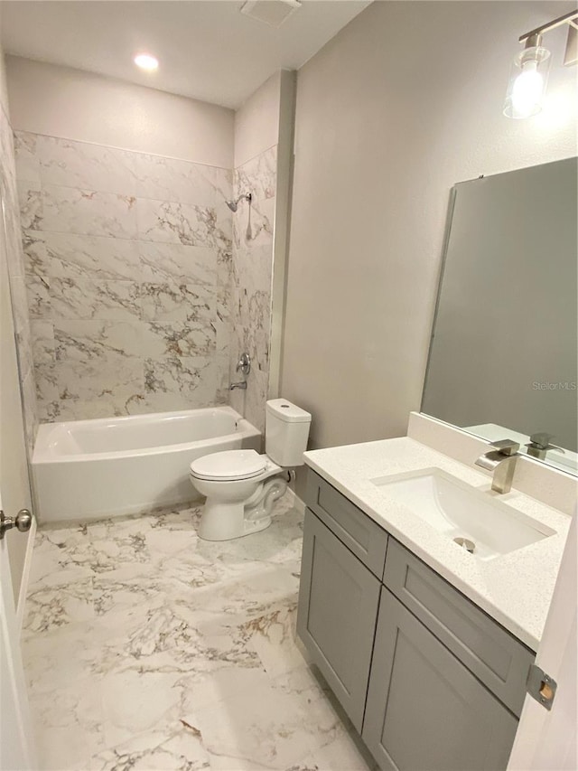 full bathroom featuring vanity, toilet, and tiled shower / bath