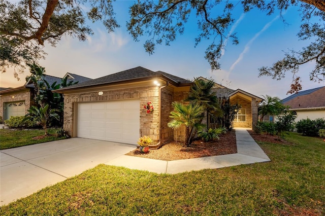 ranch-style home with a garage and a lawn