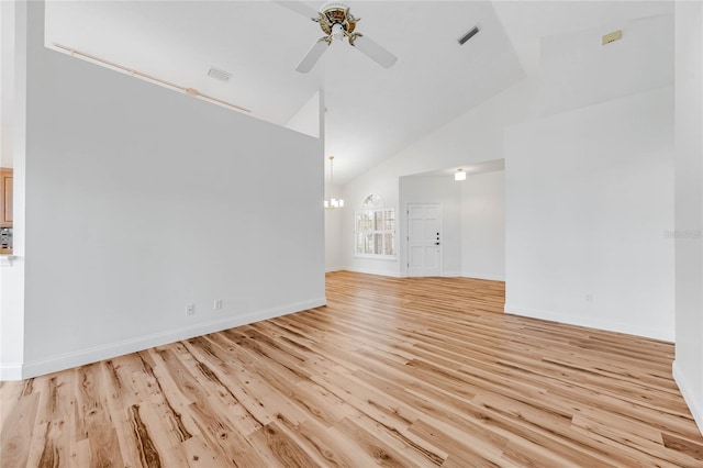 unfurnished living room featuring high vaulted ceiling, light hardwood / wood-style floors, and ceiling fan with notable chandelier