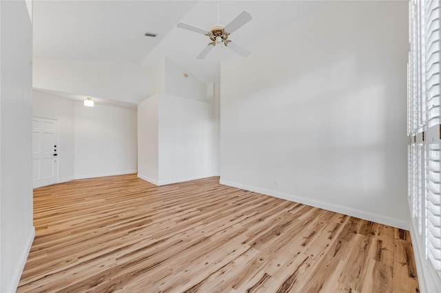 empty room with light hardwood / wood-style floors, high vaulted ceiling, and ceiling fan