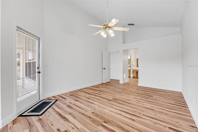 empty room featuring light hardwood / wood-style floors, high vaulted ceiling, and ceiling fan