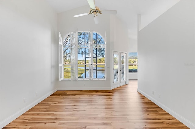 empty room featuring a wealth of natural light, french doors, and light hardwood / wood-style floors