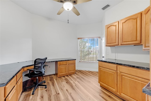 office featuring ceiling fan, light hardwood / wood-style flooring, and built in desk