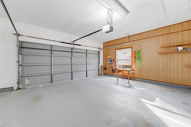 garage with wooden walls and a garage door opener