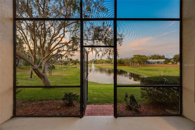 doorway featuring a water view and concrete flooring