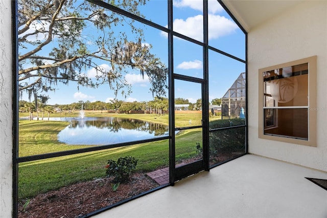 sunroom / solarium featuring a water view