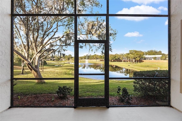 doorway featuring a water view and concrete floors