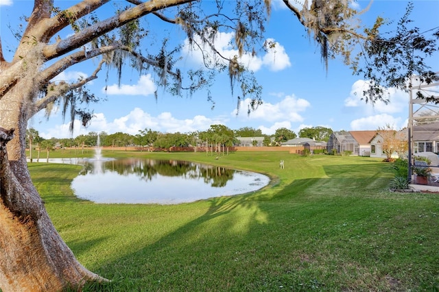 surrounding community featuring a water view and a lawn