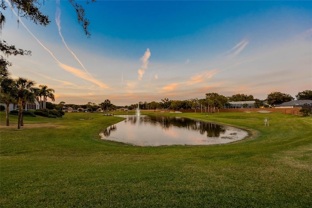 surrounding community with a yard and a water view