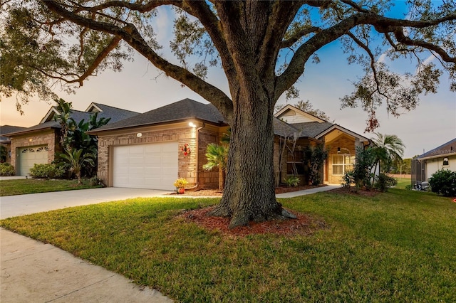 single story home with a lawn and a garage