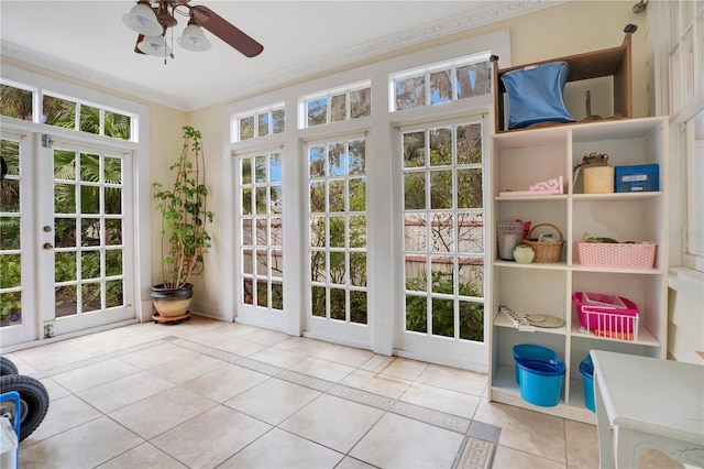 sunroom featuring ceiling fan and french doors