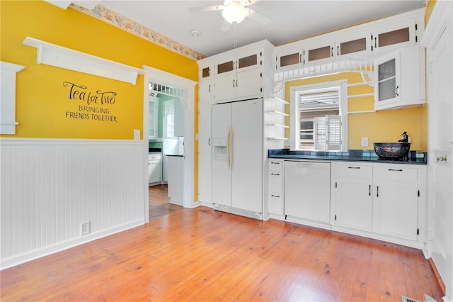 kitchen with ceiling fan, white cabinets, light hardwood / wood-style floors, and white appliances