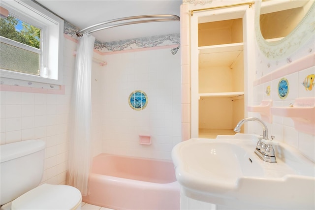 full bathroom featuring shower / tub combo with curtain, toilet, tile walls, and sink