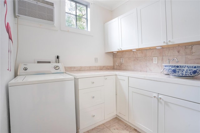 laundry room featuring cabinets, ornamental molding, a wall unit AC, washer / dryer, and light tile patterned flooring