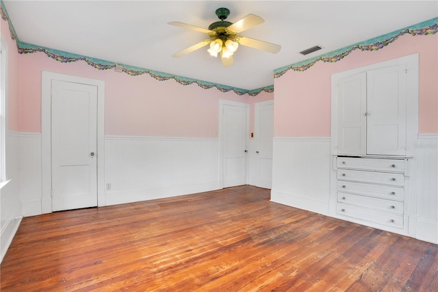 spare room with hardwood / wood-style floors and ceiling fan