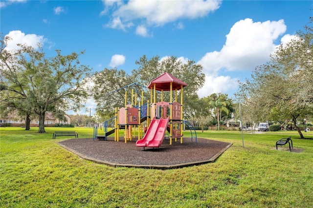 view of jungle gym with a lawn