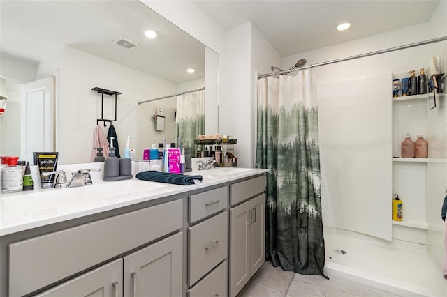 bathroom featuring vanity, tile patterned floors, and curtained shower