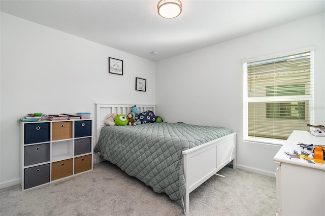 bedroom featuring light colored carpet