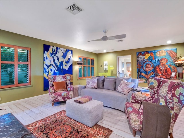 living room with ceiling fan and light wood-type flooring