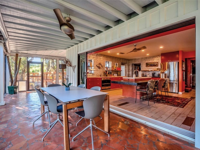 dining space with beamed ceiling, wine cooler, and ceiling fan