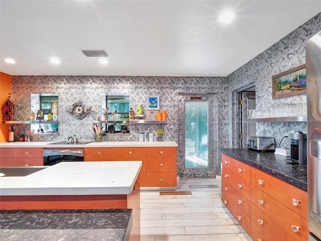 kitchen with dishwasher, sink, and light hardwood / wood-style flooring