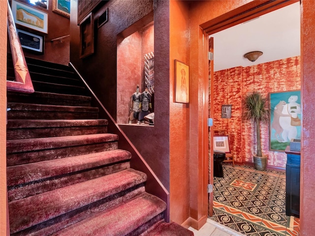 stairway featuring tile patterned floors