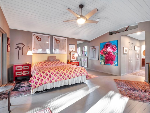 bedroom with ceiling fan, vaulted ceiling, and light wood-type flooring