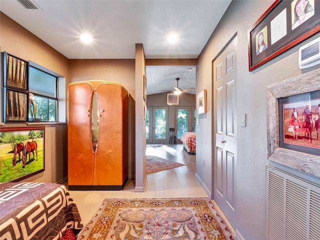 foyer featuring light hardwood / wood-style floors and vaulted ceiling