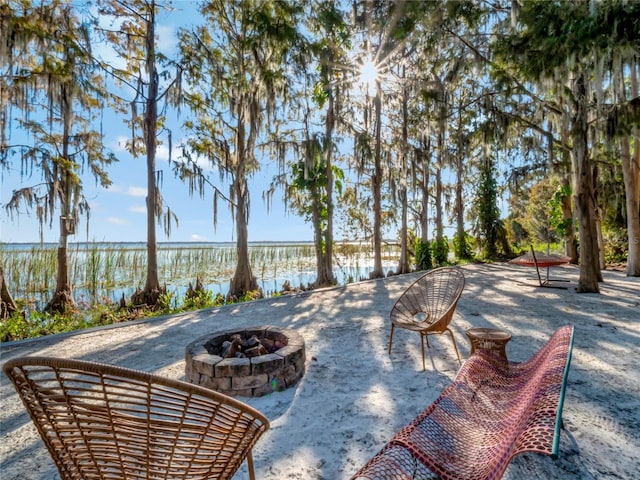 view of patio / terrace featuring a water view and an outdoor fire pit