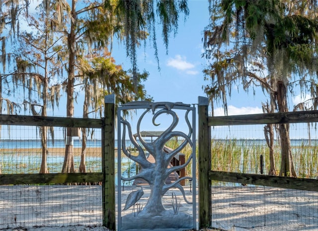 view of gate with a water view