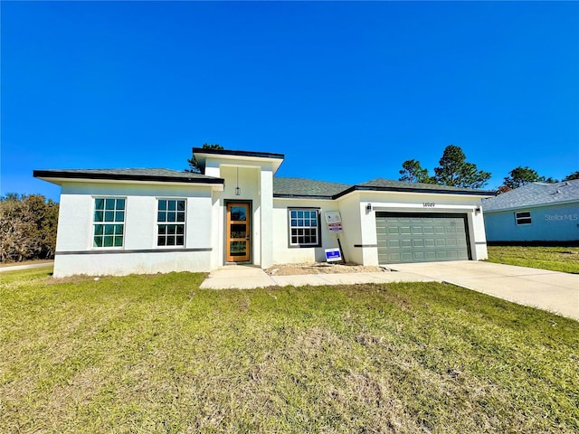 view of front of property featuring a garage and a front yard