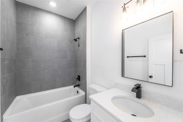 full bathroom featuring tiled shower / bath combo, toilet, and vanity