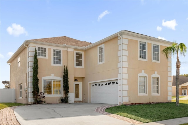 view of front facade featuring a front lawn and a garage