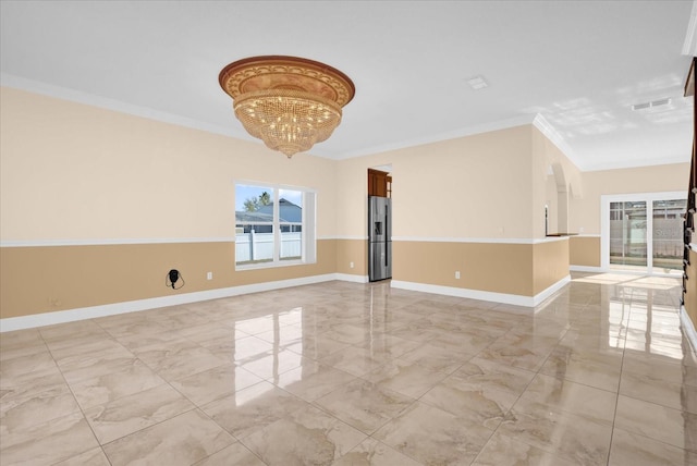 unfurnished room with an inviting chandelier and crown molding