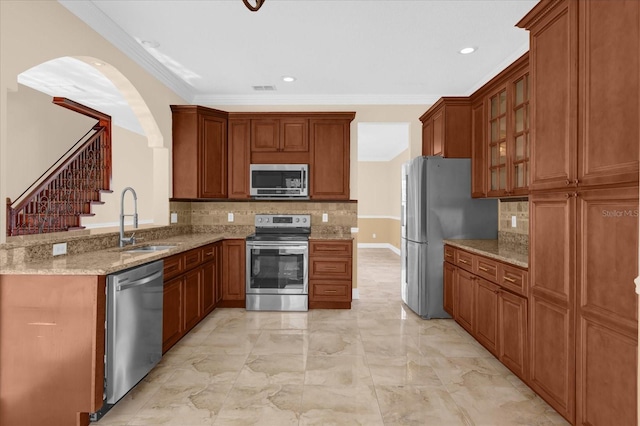 kitchen featuring backsplash, sink, ornamental molding, and appliances with stainless steel finishes