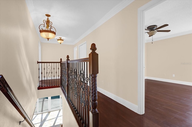 stairs featuring hardwood / wood-style floors, ceiling fan, and ornamental molding