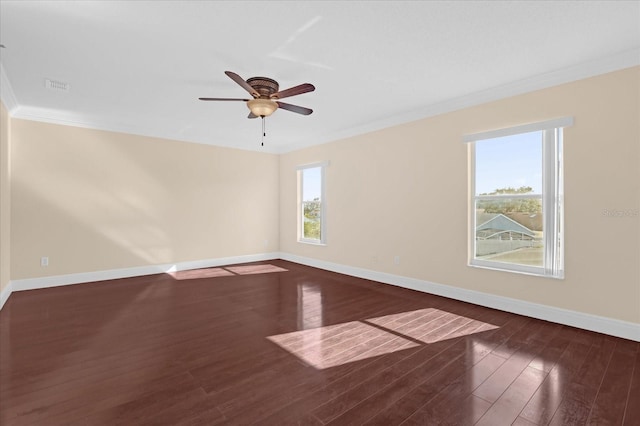 empty room featuring dark hardwood / wood-style flooring, crown molding, plenty of natural light, and ceiling fan