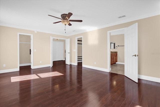 empty room with dark hardwood / wood-style flooring, ceiling fan, and crown molding