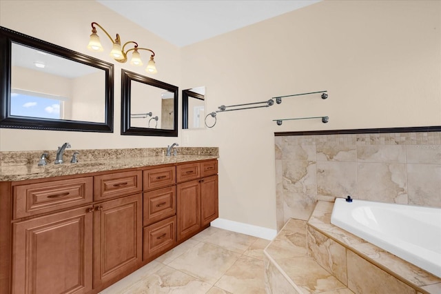 bathroom with tiled tub and vanity