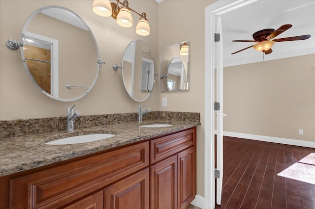 bathroom featuring ceiling fan, wood-type flooring, and vanity