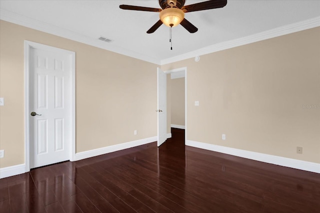 empty room with crown molding, dark hardwood / wood-style flooring, and ceiling fan